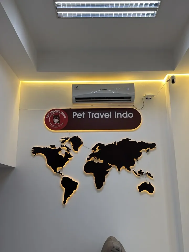 Pet Travel Indo sign and world map on the office wall
